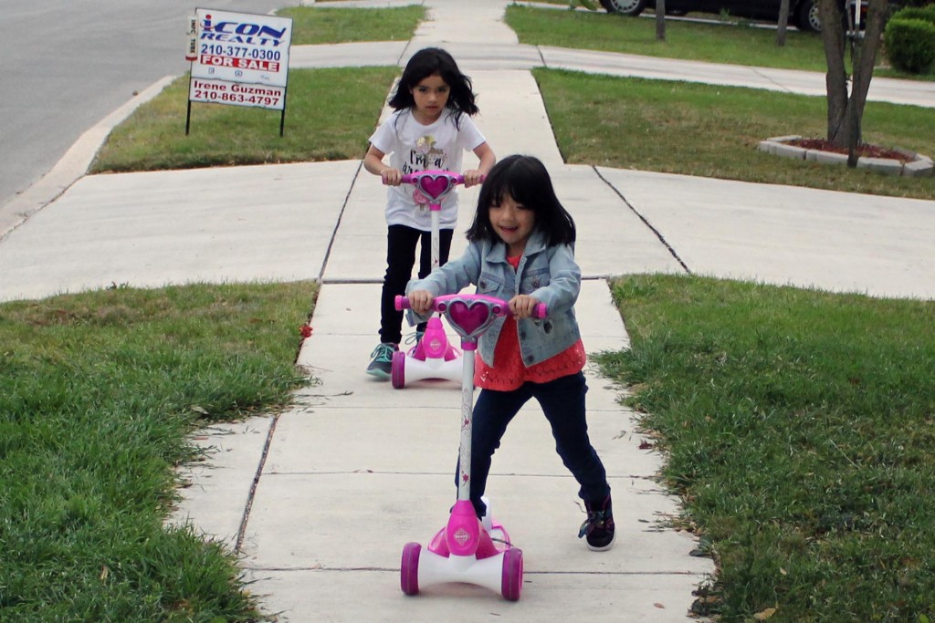 Farrah Guerrero, 6, races her sister Savannah, 8, outside of their home in NW San Antonio. Photo by Brandon Tomescko